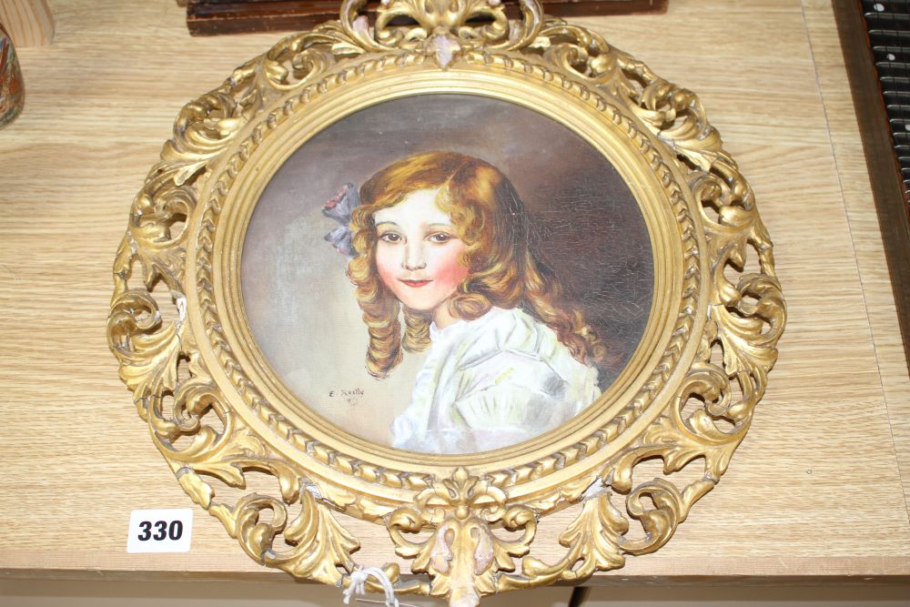 A gilt framed oil portrait of a young lady signed E. Reilly, diameter 22cm, overall 40cm, and two woolwork floral panels, 37 x 26cm